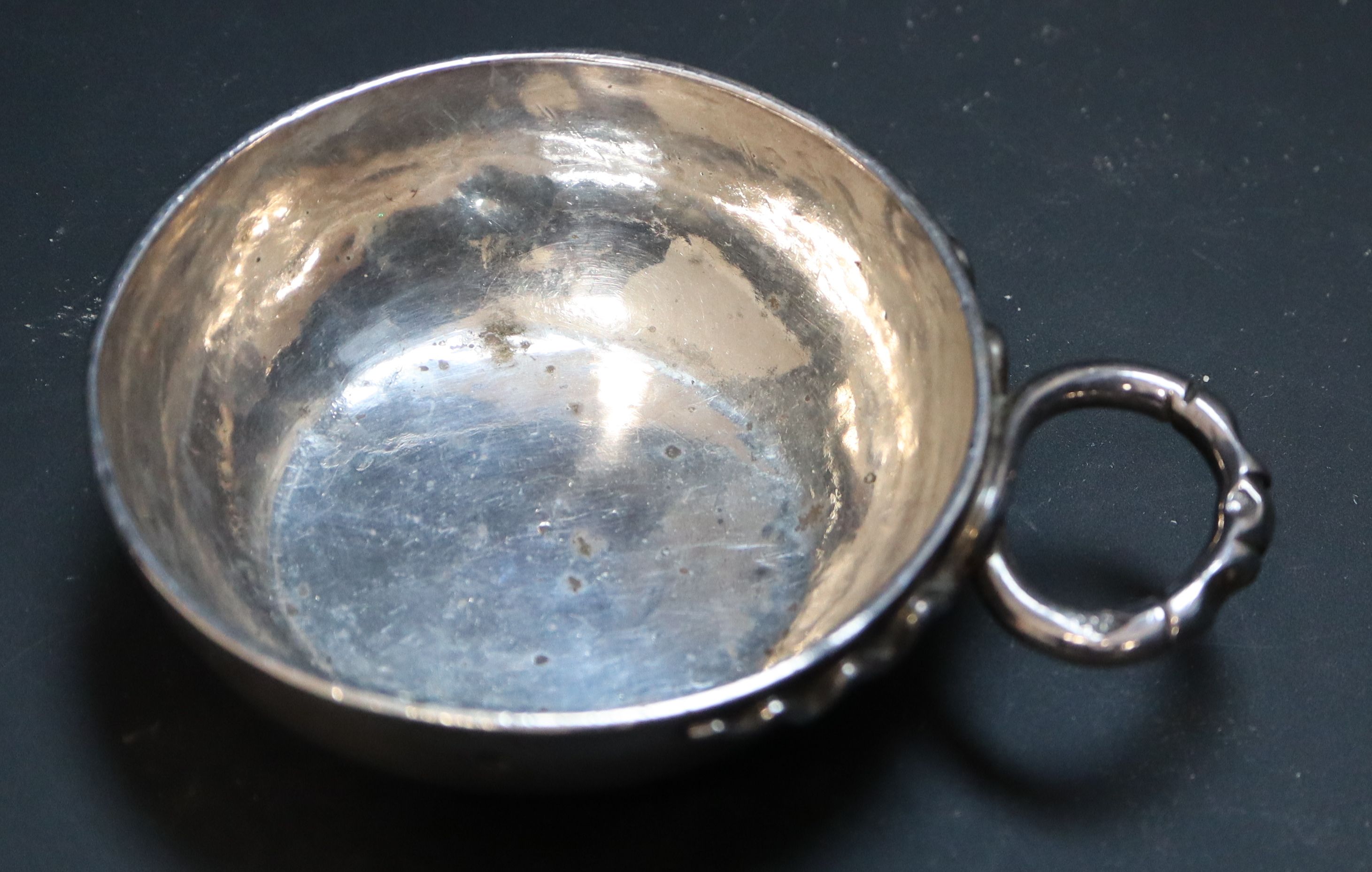 A 19th century French white metal wine taster, diameter 7.6cm, 3.5oz.